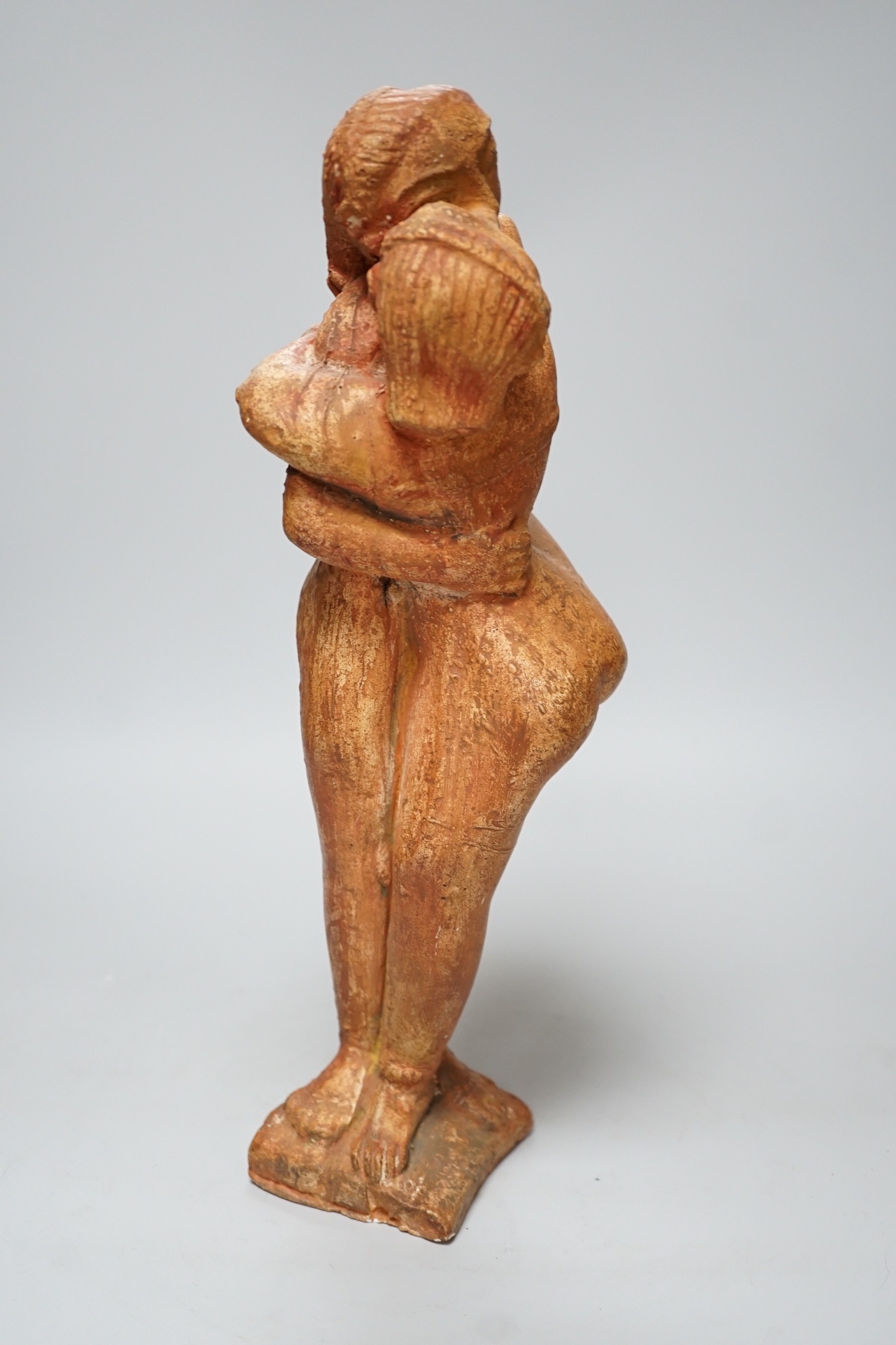 A painted plaster figure of an embracing Indian couple, 37cm tall